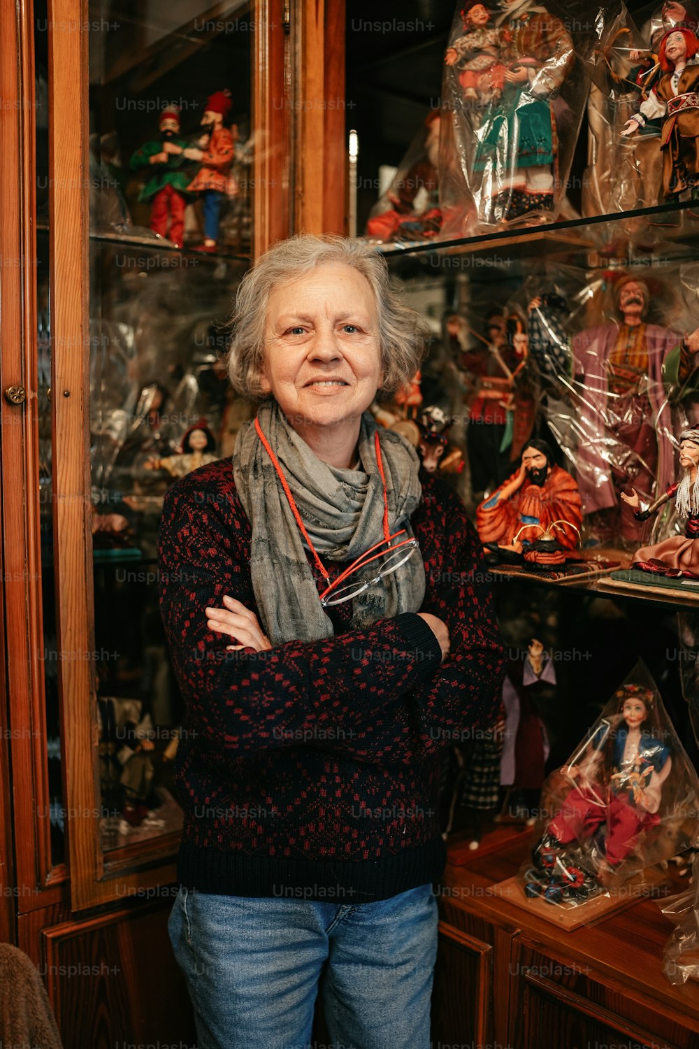 a woman standing in front of a display case filled with figurines