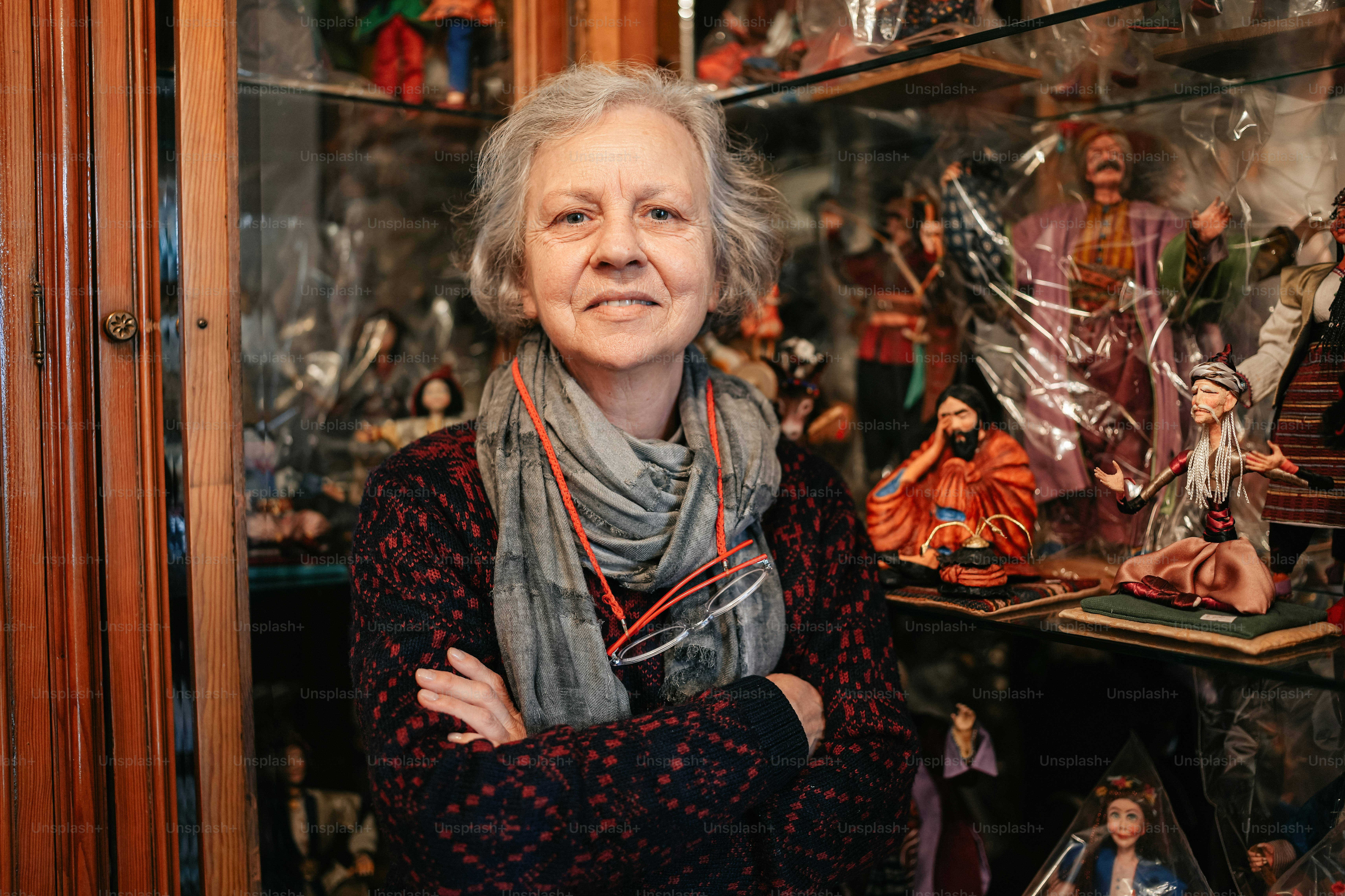 a woman standing in front of a display case filled with figurines