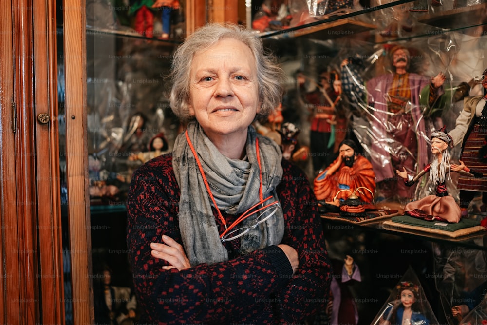 una donna in piedi davanti a una vetrina piena di figurine