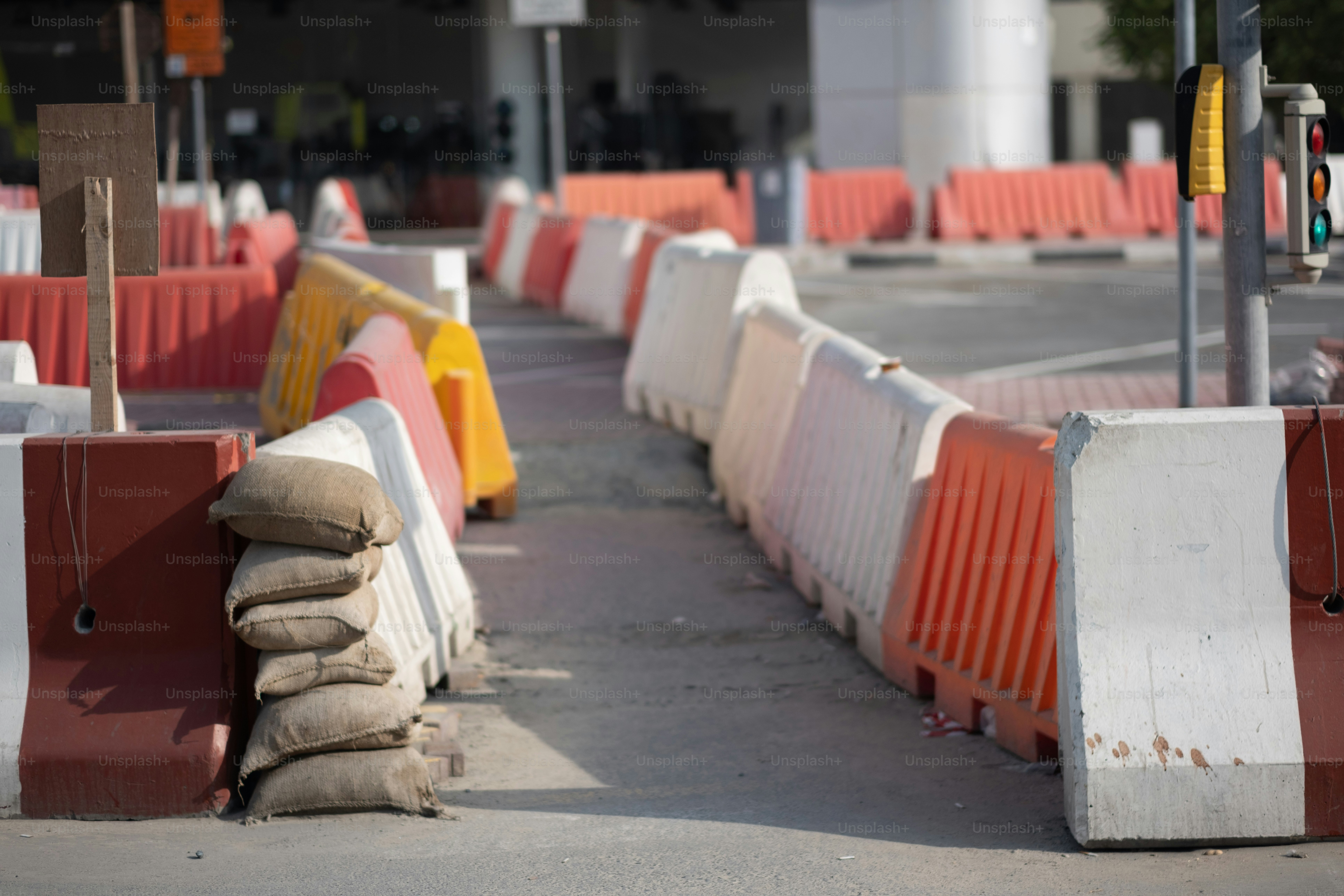 Jersey barriers defining a walkway at a construction site.