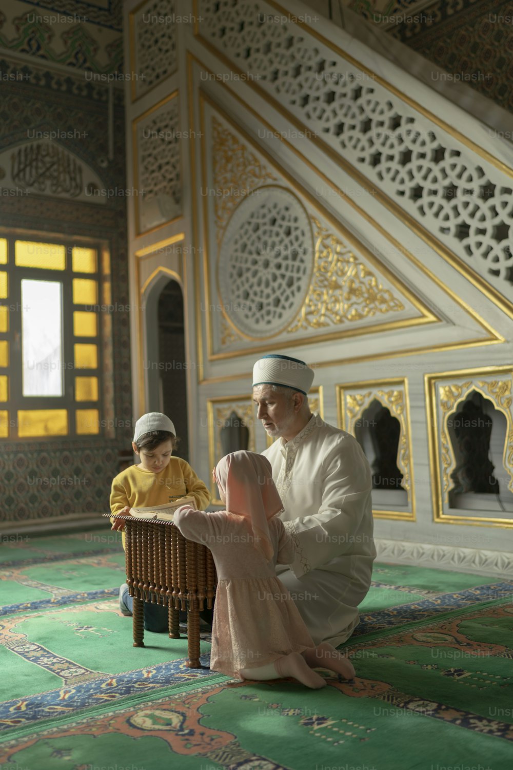 a man sitting on a chair next to a little boy