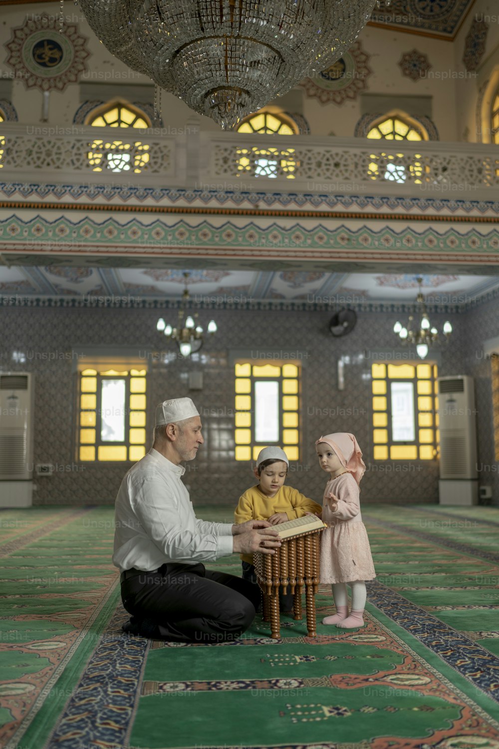 a man kneeling down next to a little girl