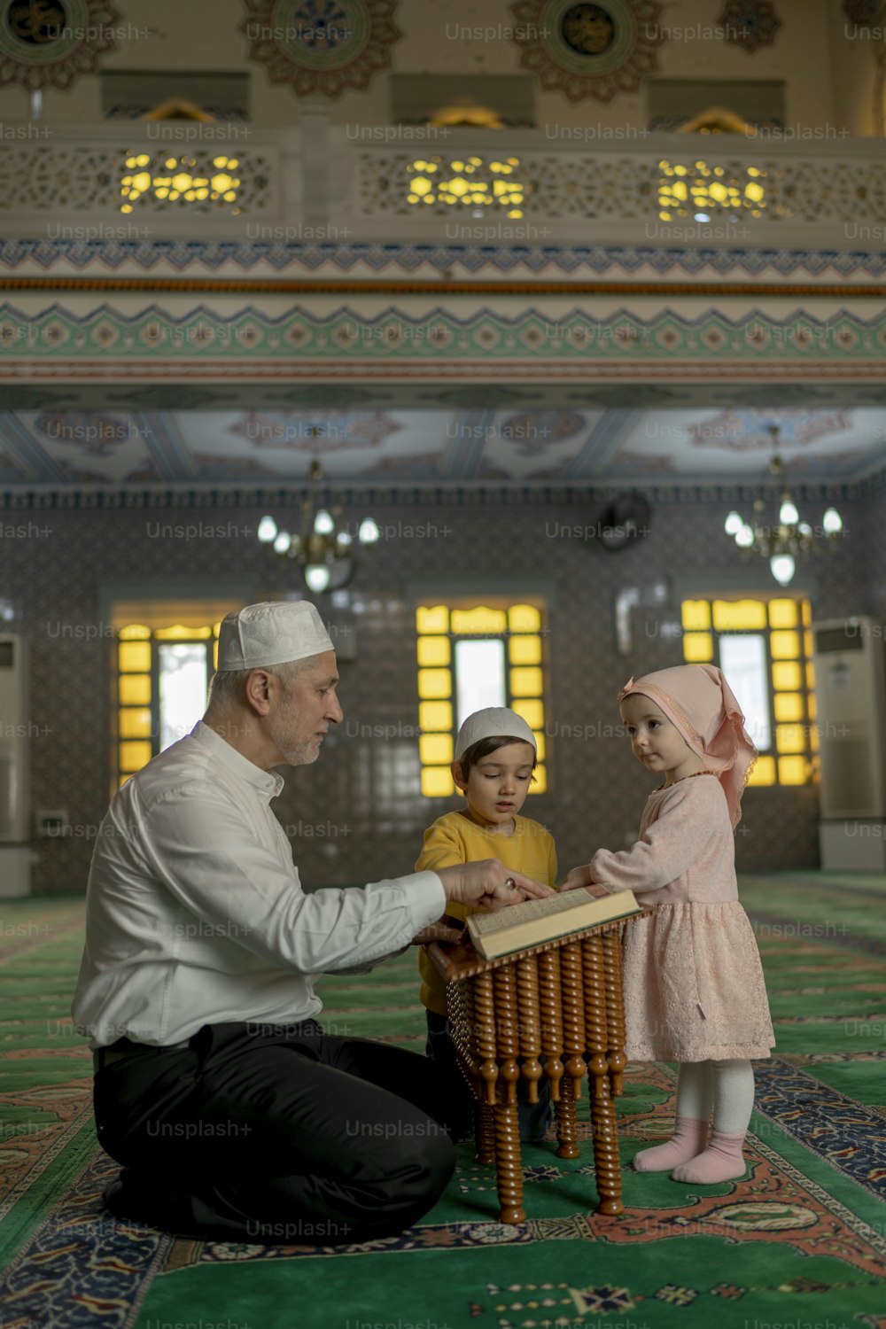 a man kneeling down next to a little girl