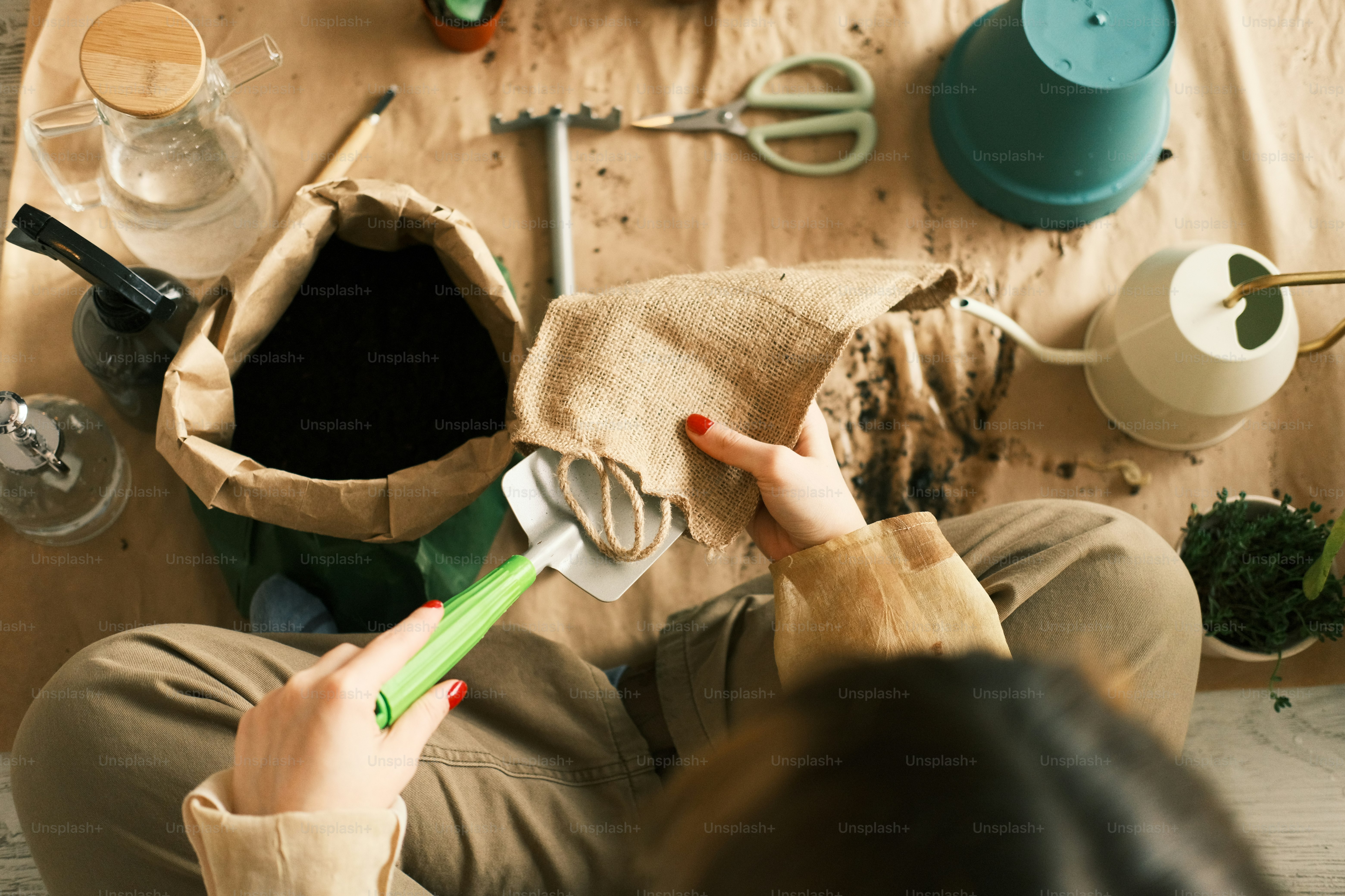 a woman holding a green toothbrush in her right hand