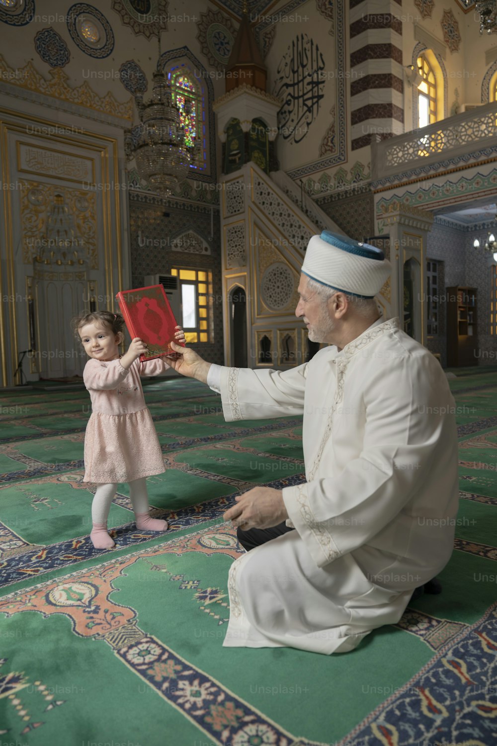 a man kneeling on the floor with a little girl