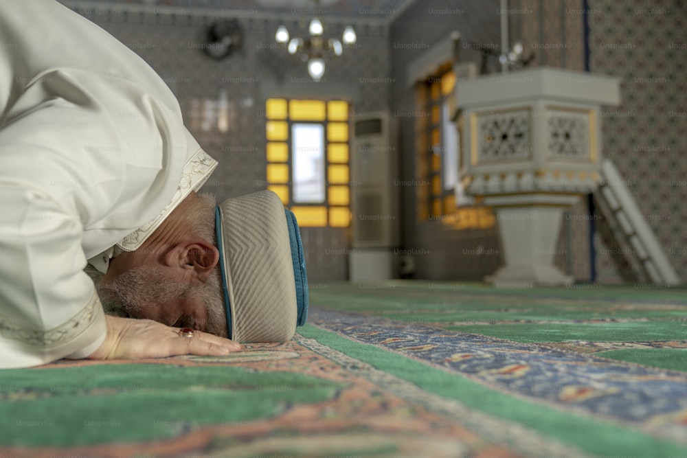 a man laying on the floor with his head in his hands