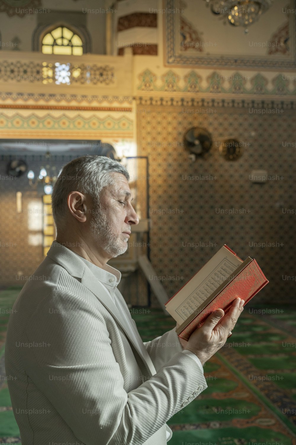 a man reading a book in a mosque