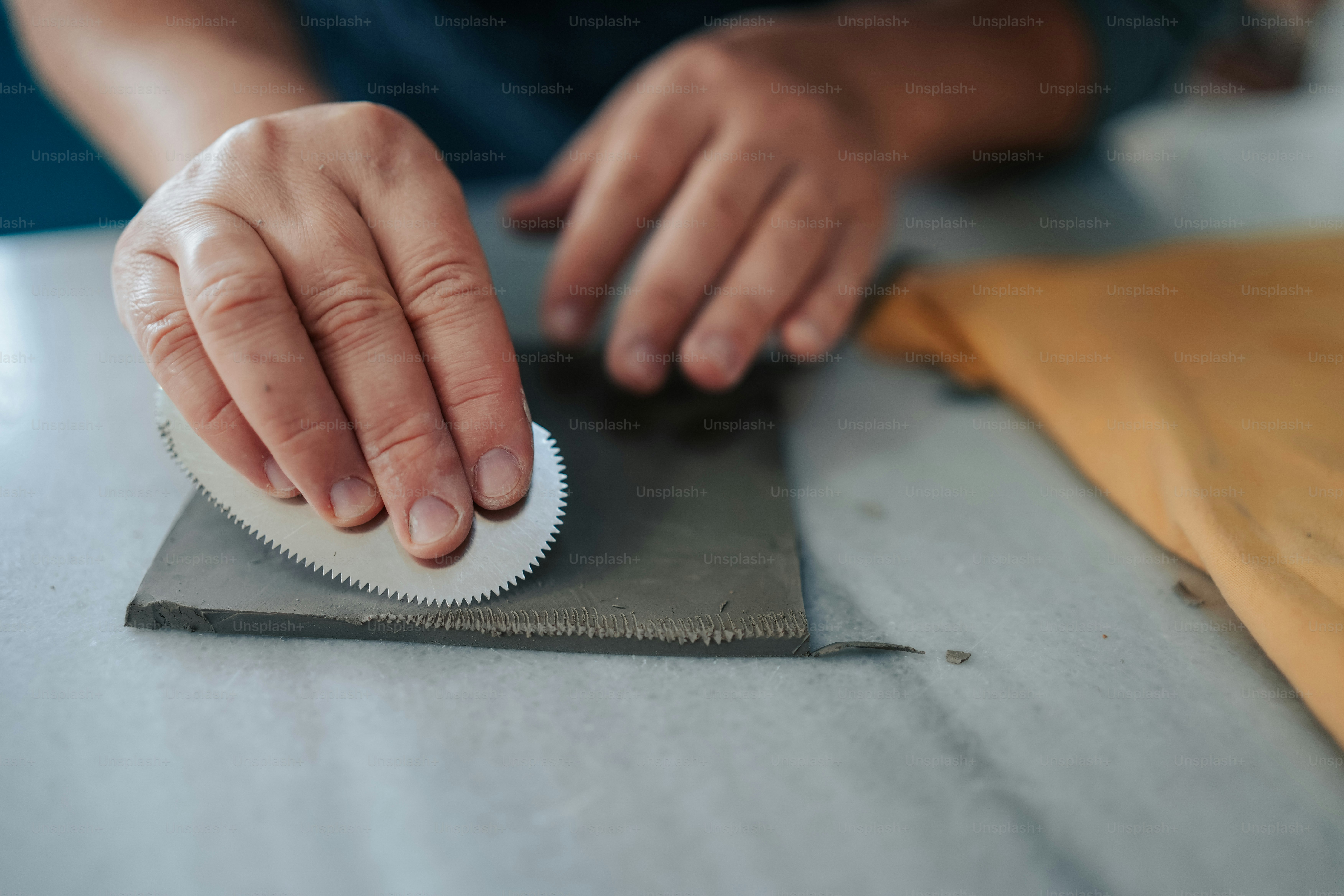 a person with their hand on a piece of metal