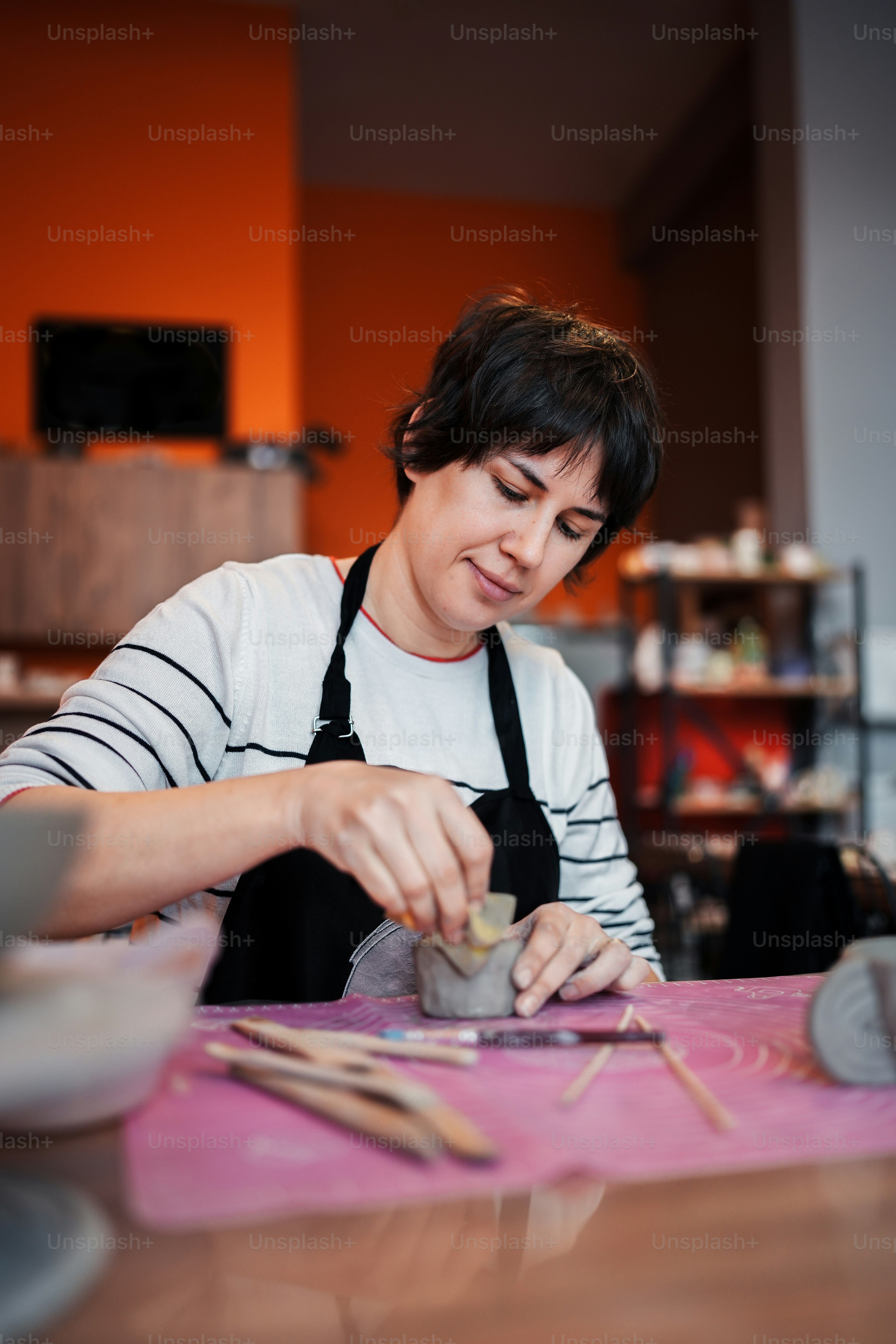 a woman in an apron is making something