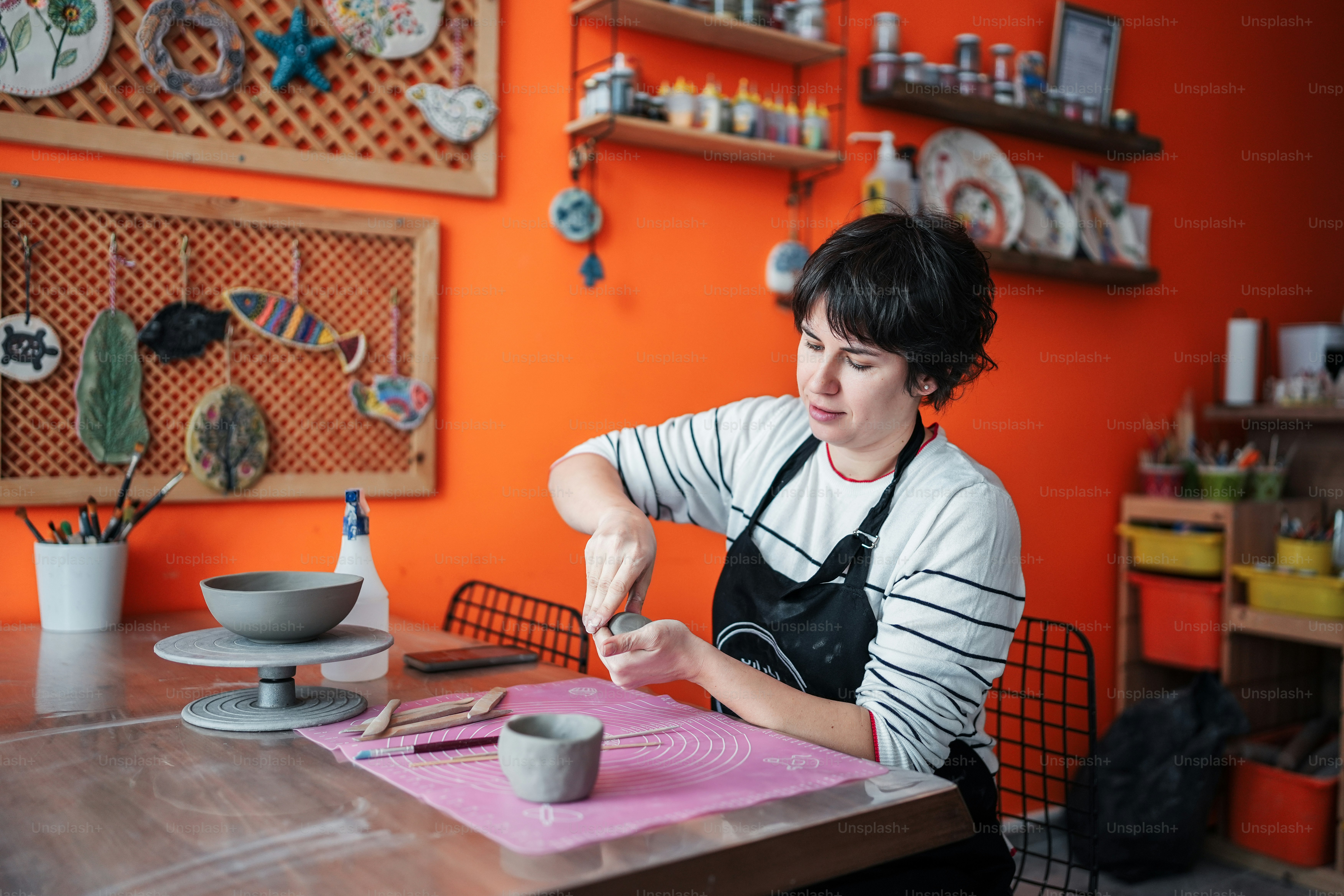 a woman sitting at a table in front of a cup