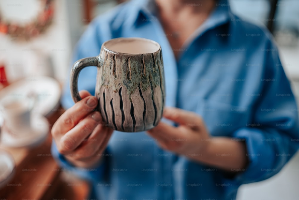 a person holding a coffee mug in their hands
