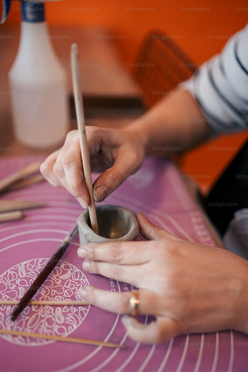 a person holding a pair of chopsticks over a bowl