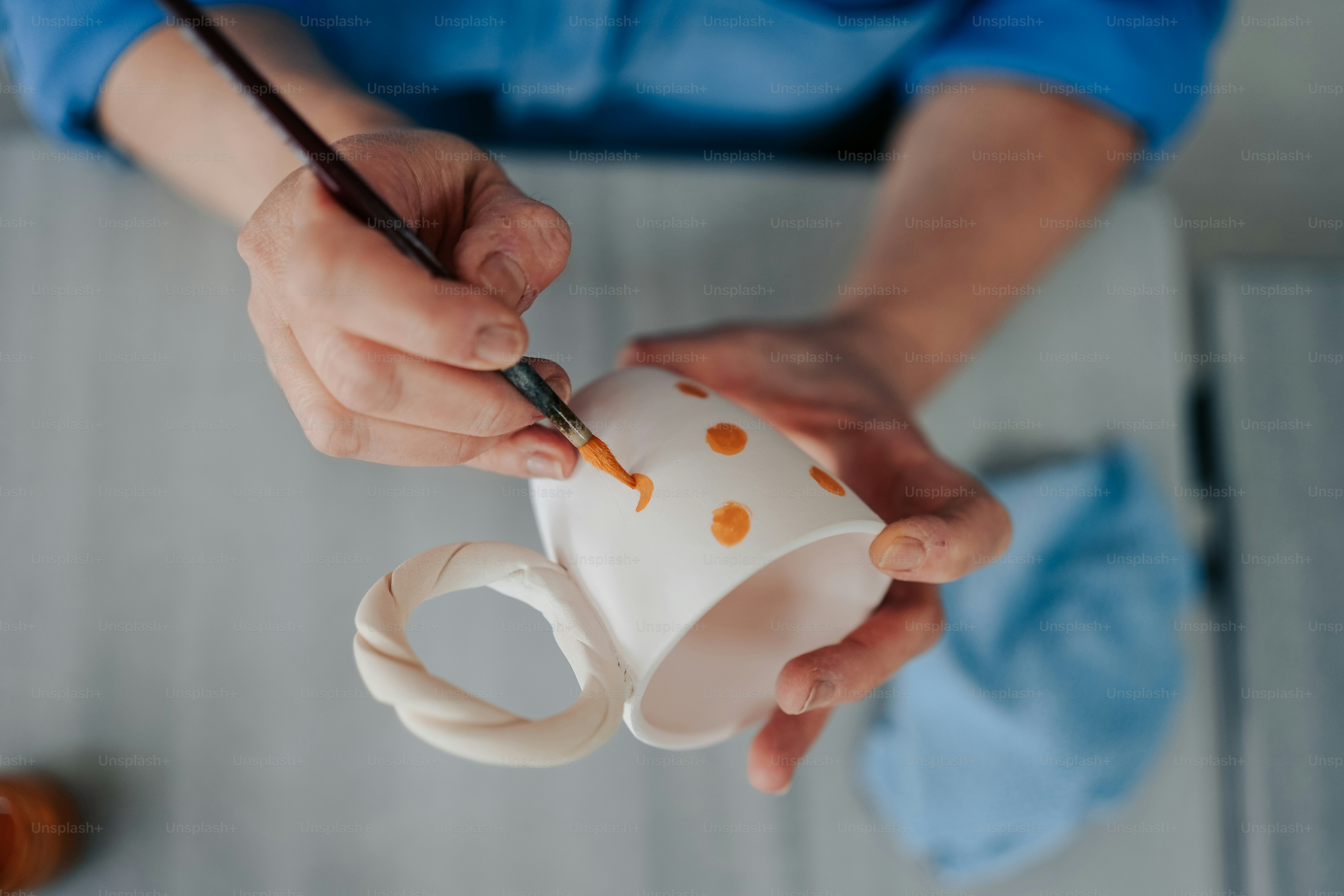 a person holding a cup with a brush in it