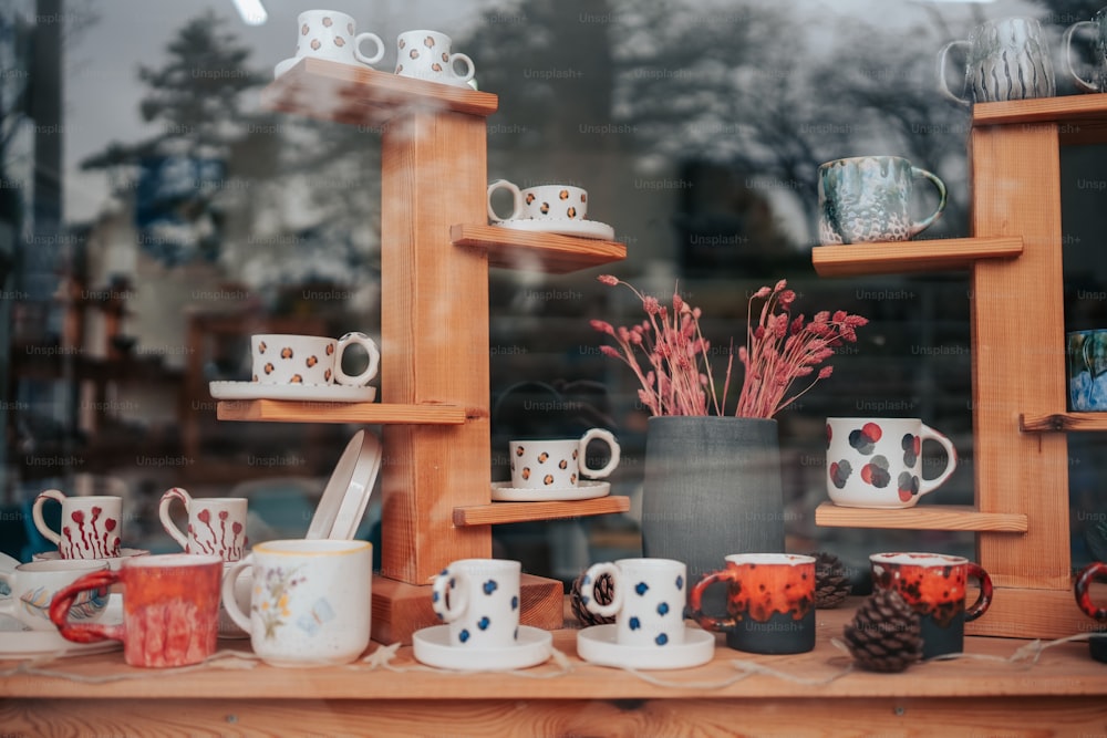 a window display of coffee cups and mugs