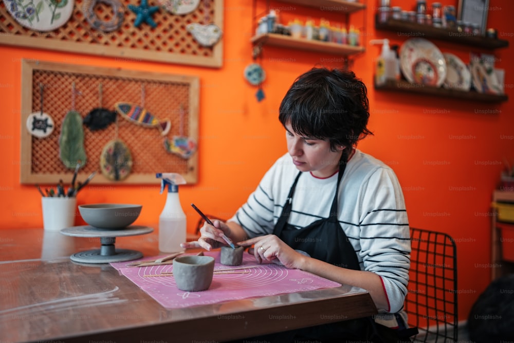 a woman sitting at a table with a bowl of food