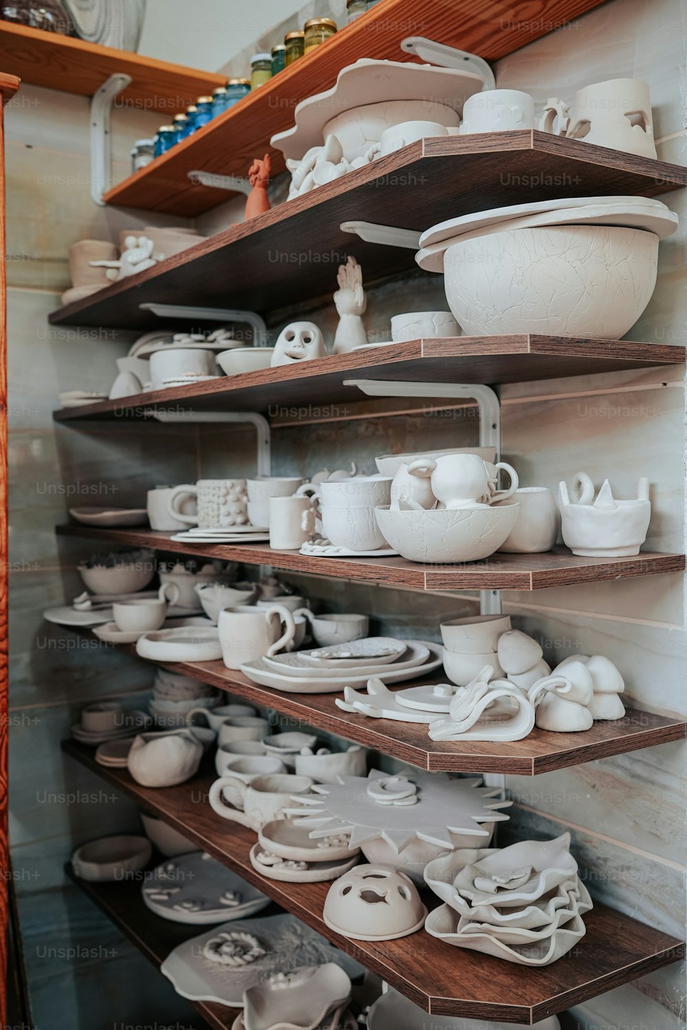 a shelf filled with lots of white dishes