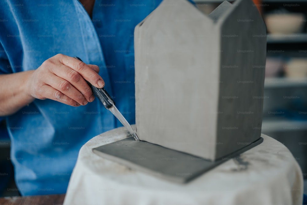 a person cutting a cake with a knife