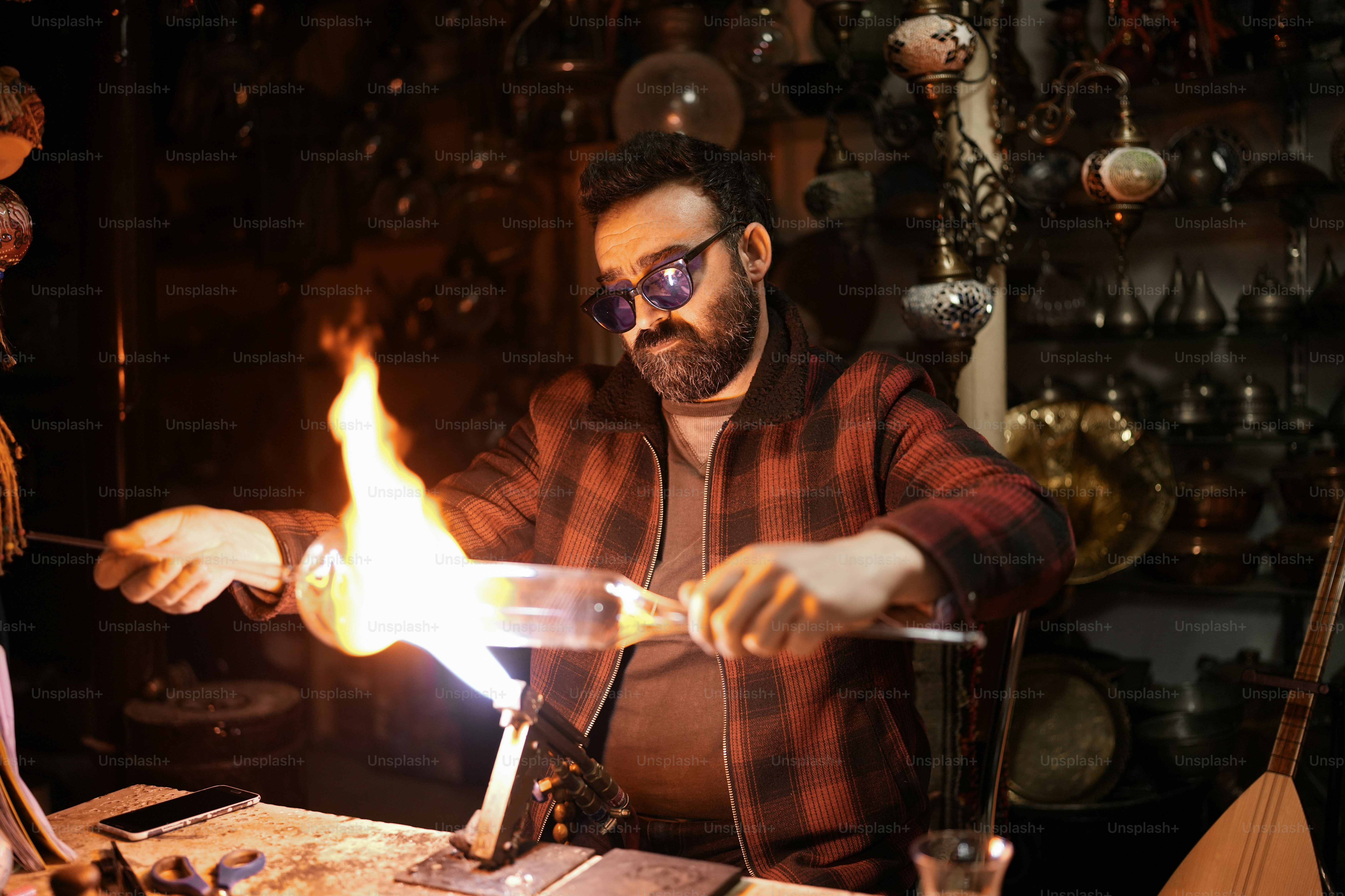 a man is working with a flame in a shop