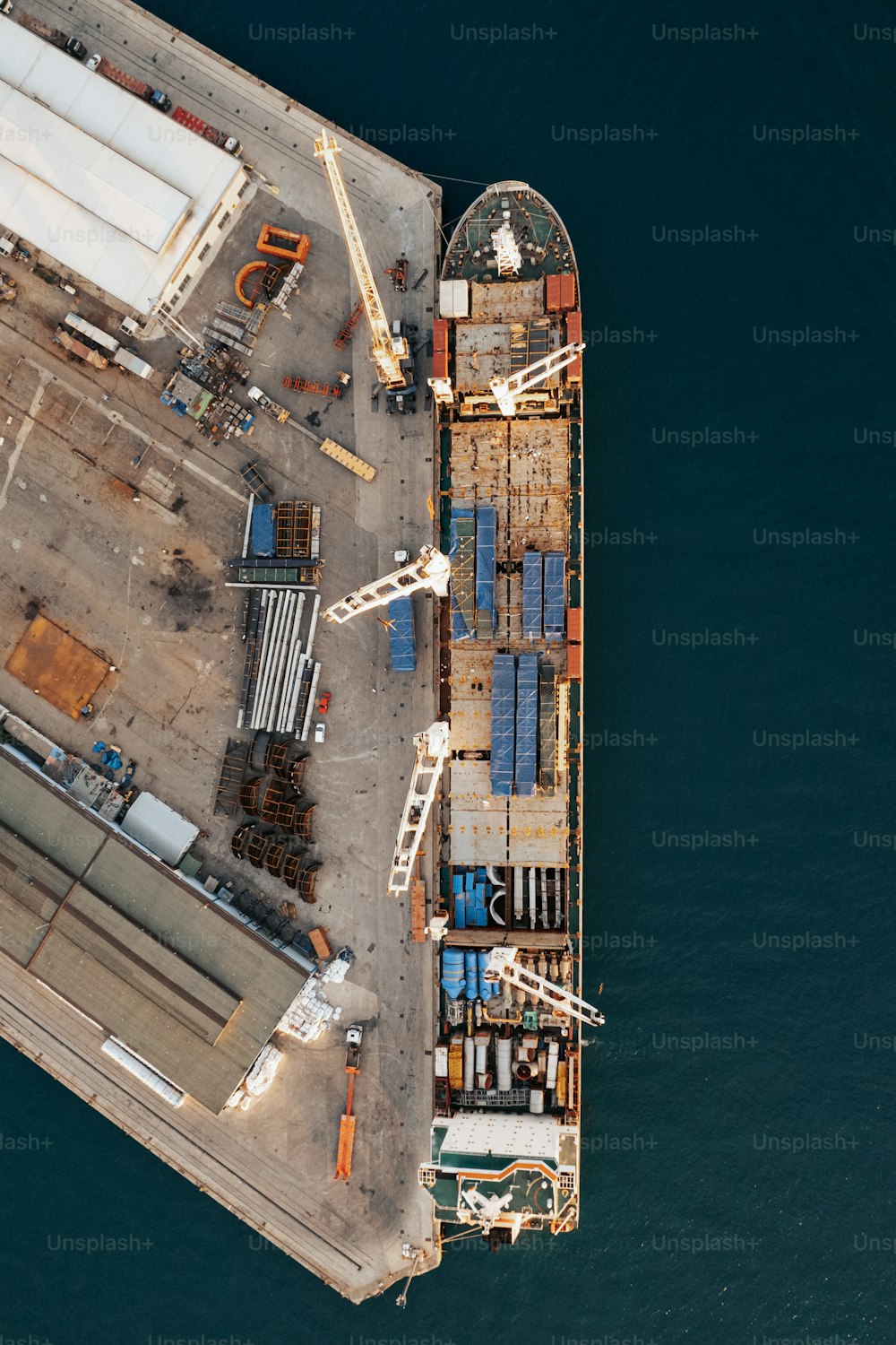 an aerial view of a cargo ship in the water