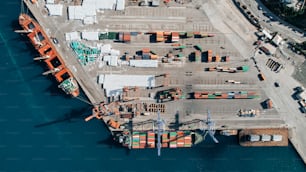 an aerial view of a cargo ship docked at a dock