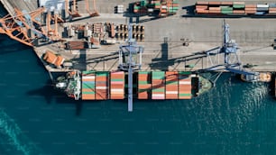 an aerial view of a cargo ship in the water