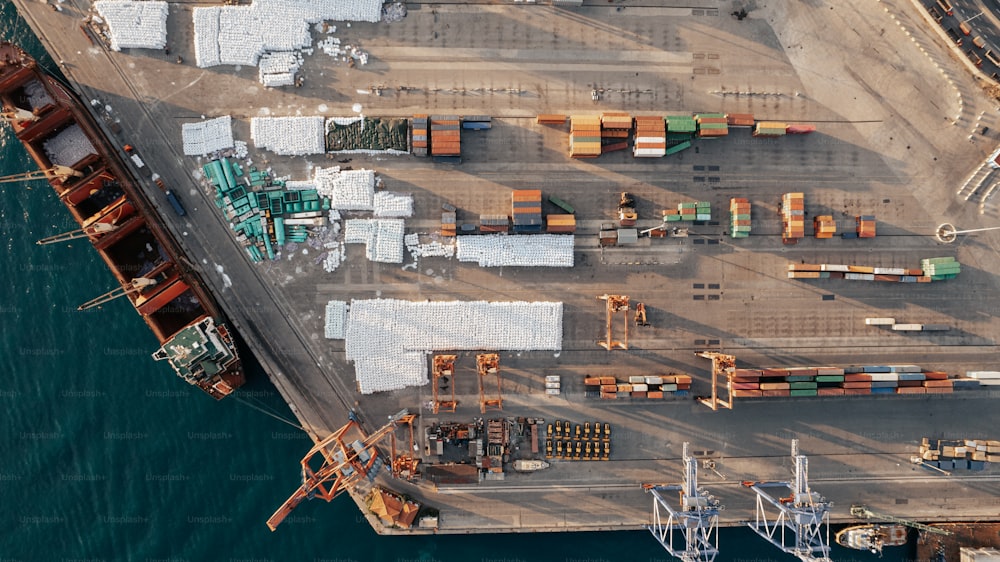 an aerial view of a cargo ship docked at a dock