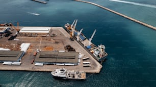 an aerial view of a dock with a boat in the water