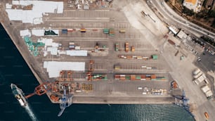 an aerial view of a cargo ship docked at a port