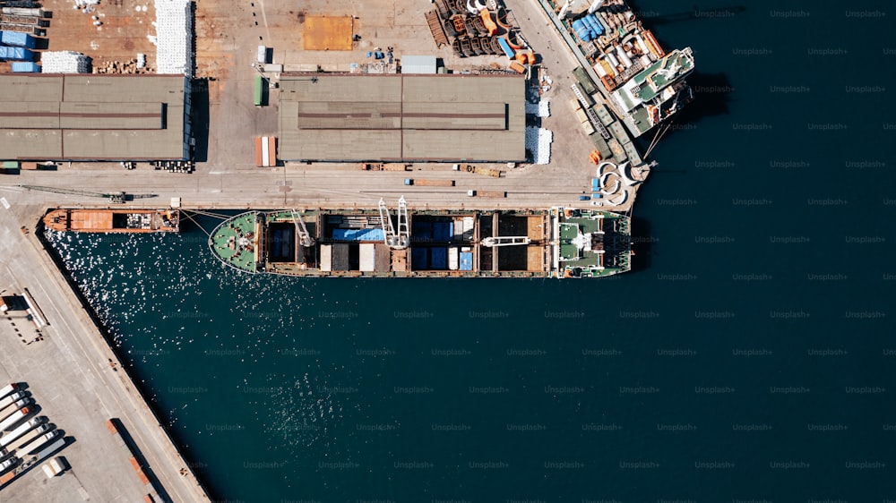 an aerial view of a cargo ship docked at a dock