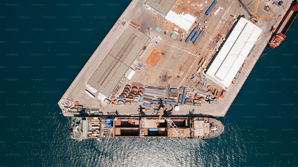 an aerial view of a cargo ship in the water