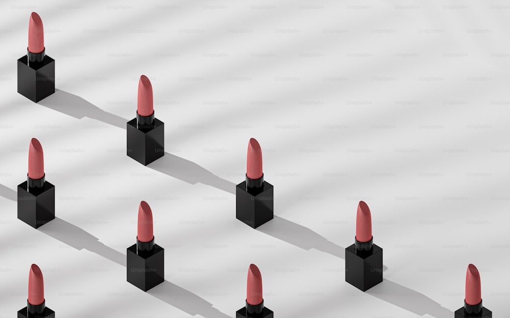 a group of black and red lipsticks sitting on top of each other