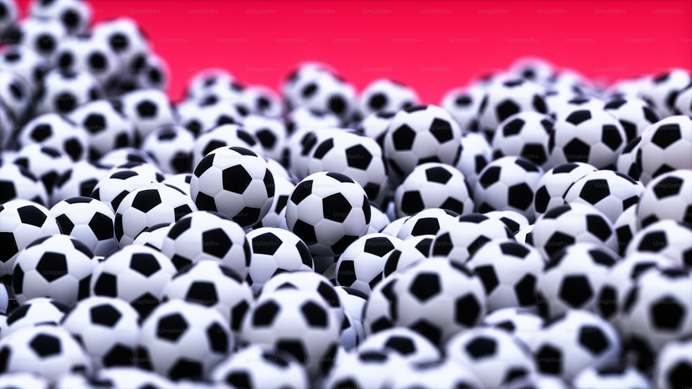 a large group of black and white soccer balls