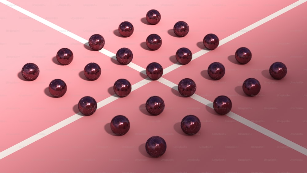 a group of shiny balls sitting on top of a pink surface