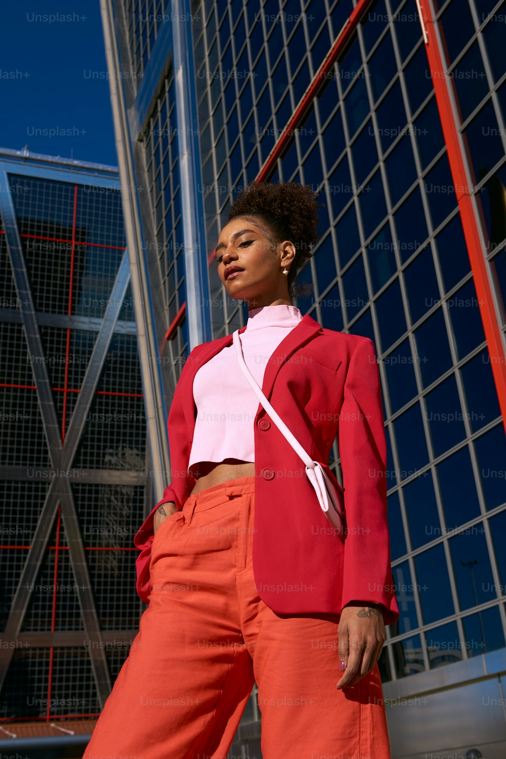 a woman standing in front of a tall building