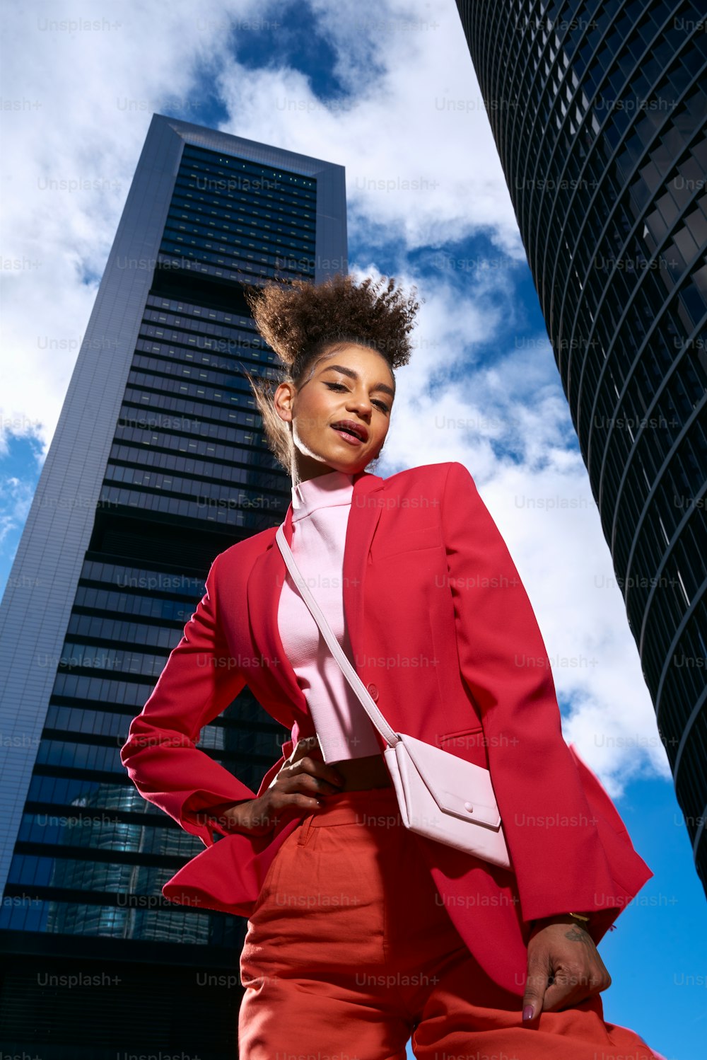a woman standing in front of a tall building