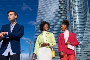 a group of people standing in front of a tall building