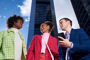 a group of people standing in front of a tall building