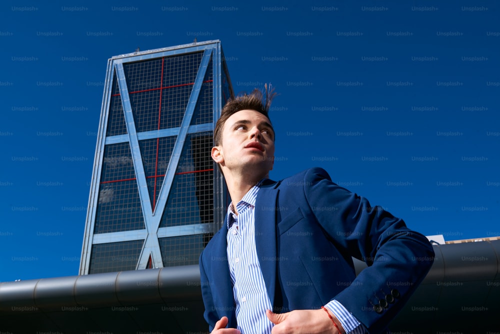 a man in a suit standing in front of a building