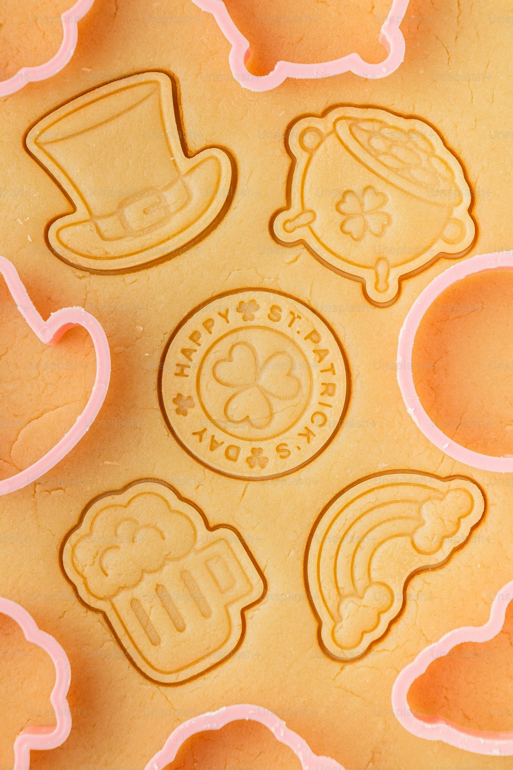 a close up of a cookie sheet with cookies in the shape of shamrocks
