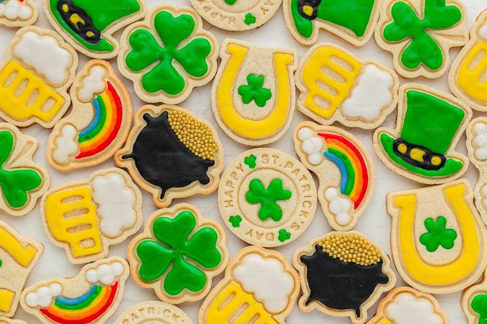 a table topped with lots of decorated cookies