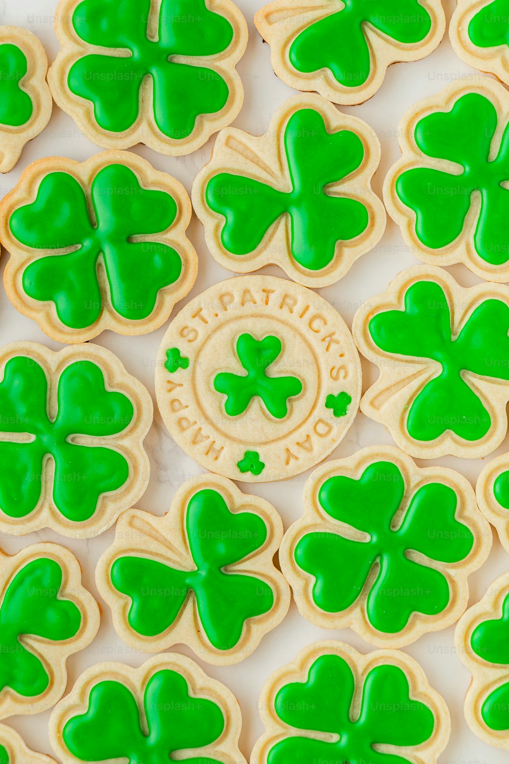 a close up of a plate of shamrock cookies