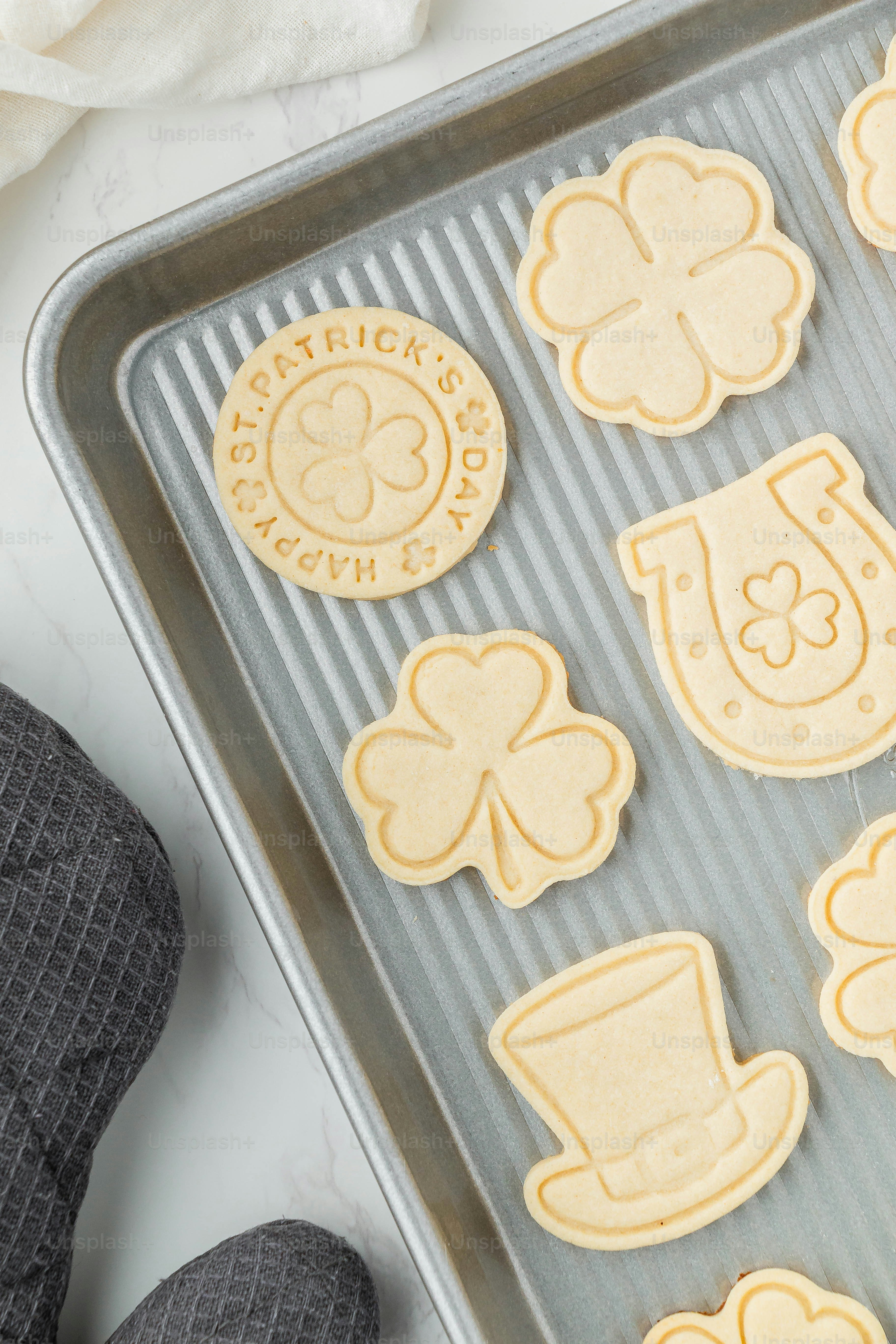 a pan filled with cut out cookies on top of a table