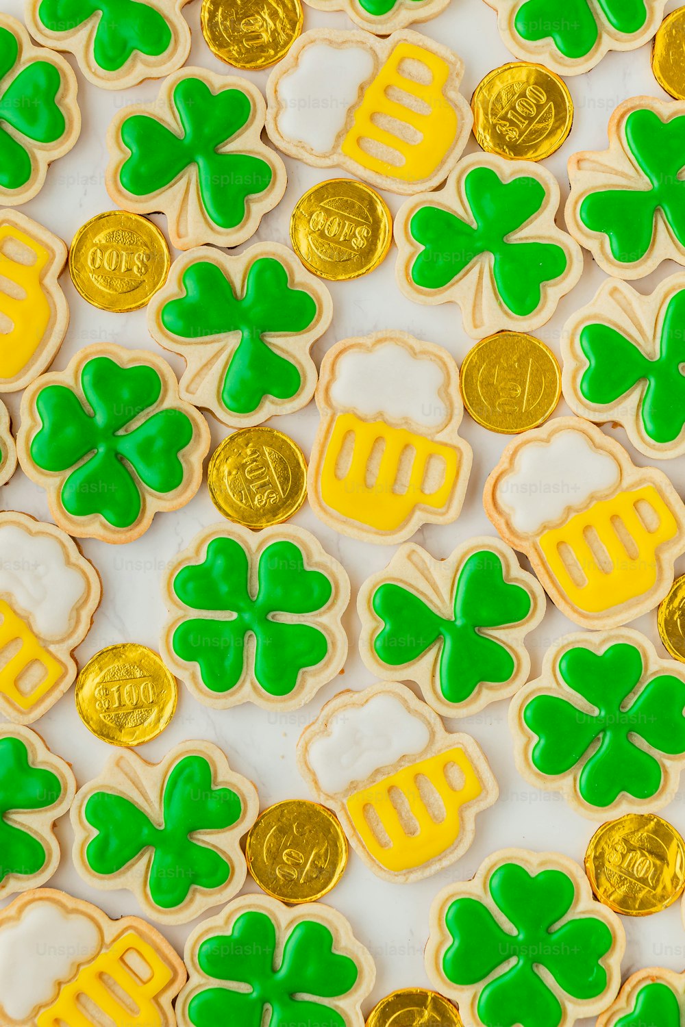 a table topped with lots of green and yellow cookies