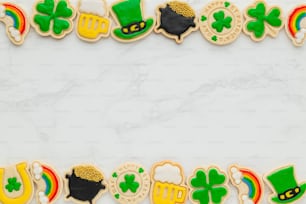 a white marble table topped with lots of decorated cookies