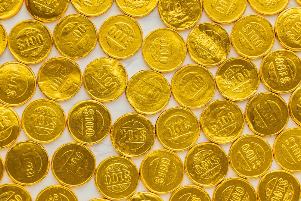 a lot of gold coins sitting on top of a table