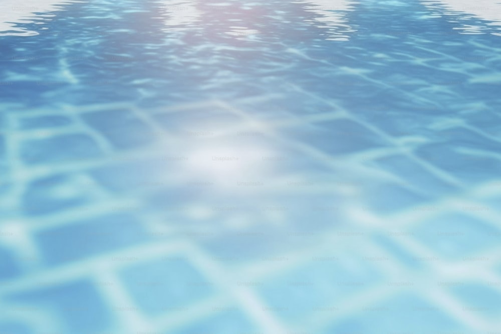 a blue swimming pool with the sun reflecting on the water