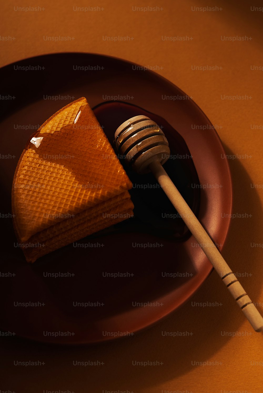 a piece of cake on a plate with a wooden stick