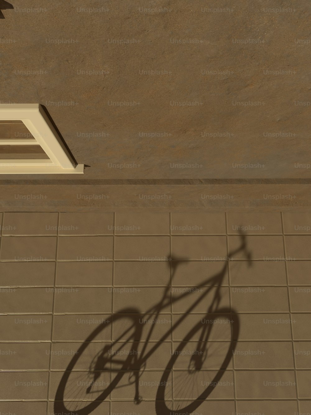 a shadow of a bicycle on a tile floor