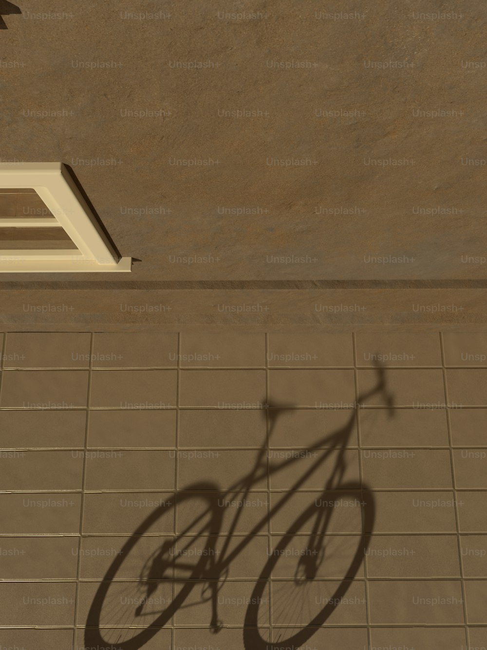 uma sombra de uma bicicleta em um piso de azulejo