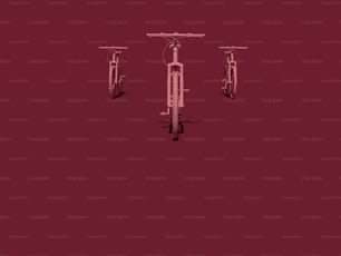 three bicycles are shown against a red background